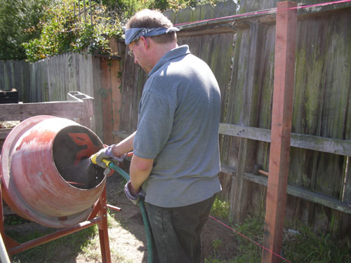 Noel mixing concrete for a post hole