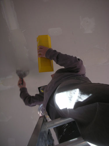 Up on a ladder, plastering