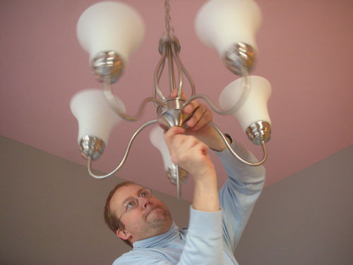 Noel assembles the lighting fixture