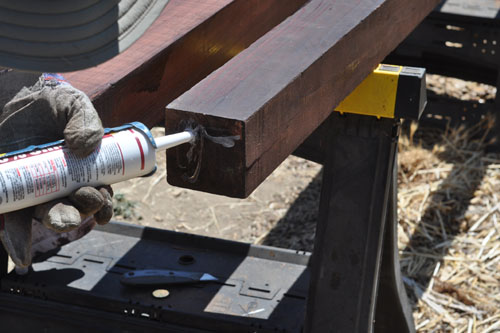 Sealing the bottom of each post with silicone