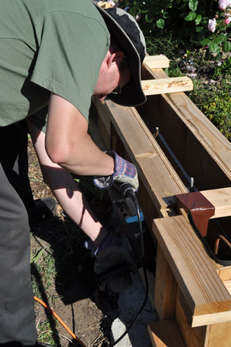 Noel using the hammer drill to lock the forms in place