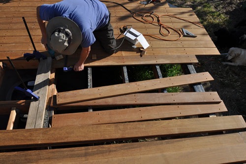 Putting down boards by the stairs