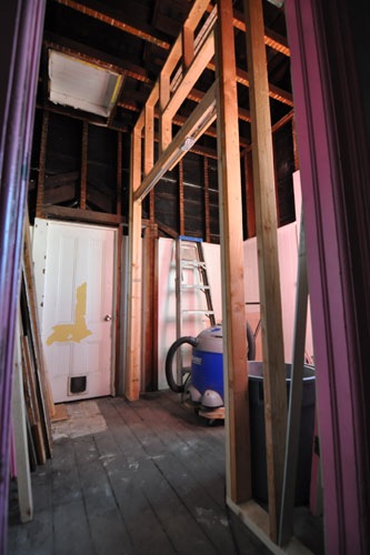 Bathroom wall with pocket door hardware and transom