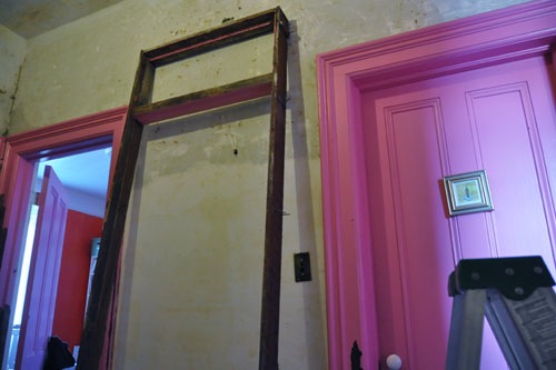 The door frame out and leaning against the hall wall