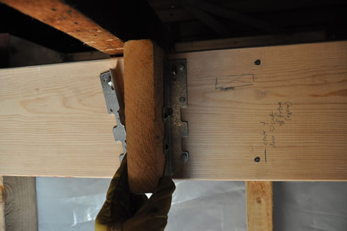 Using a scrap to attach the joist hanger