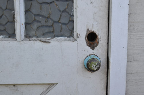 Old lock hole with rat scratches