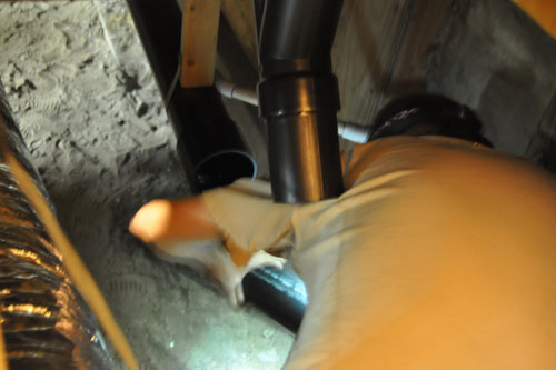 Noel working in the crawlspace