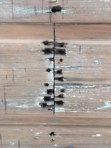 Where the nails have rotted the wood